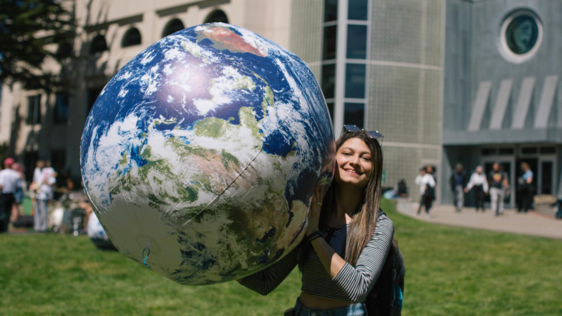 Student holding globe