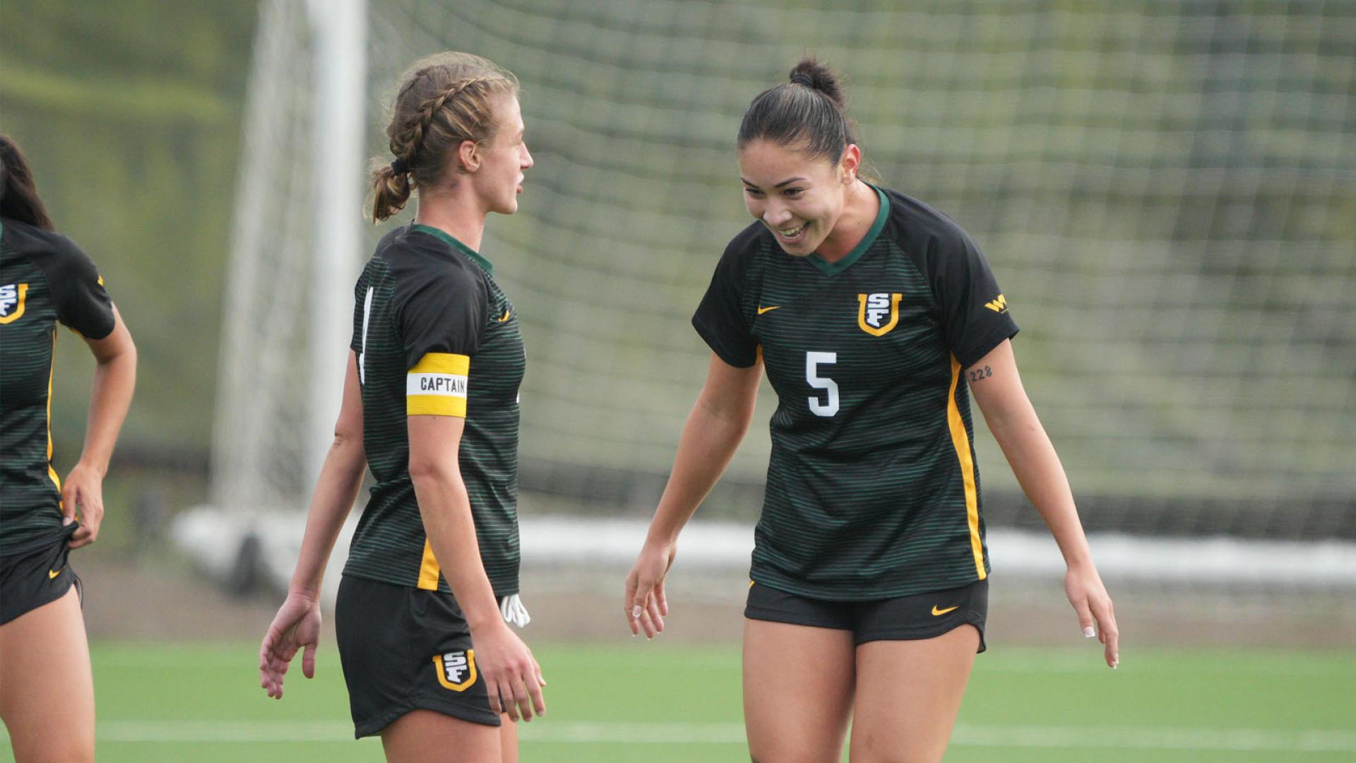 USF women&#039;s soccer players celebrates on field.