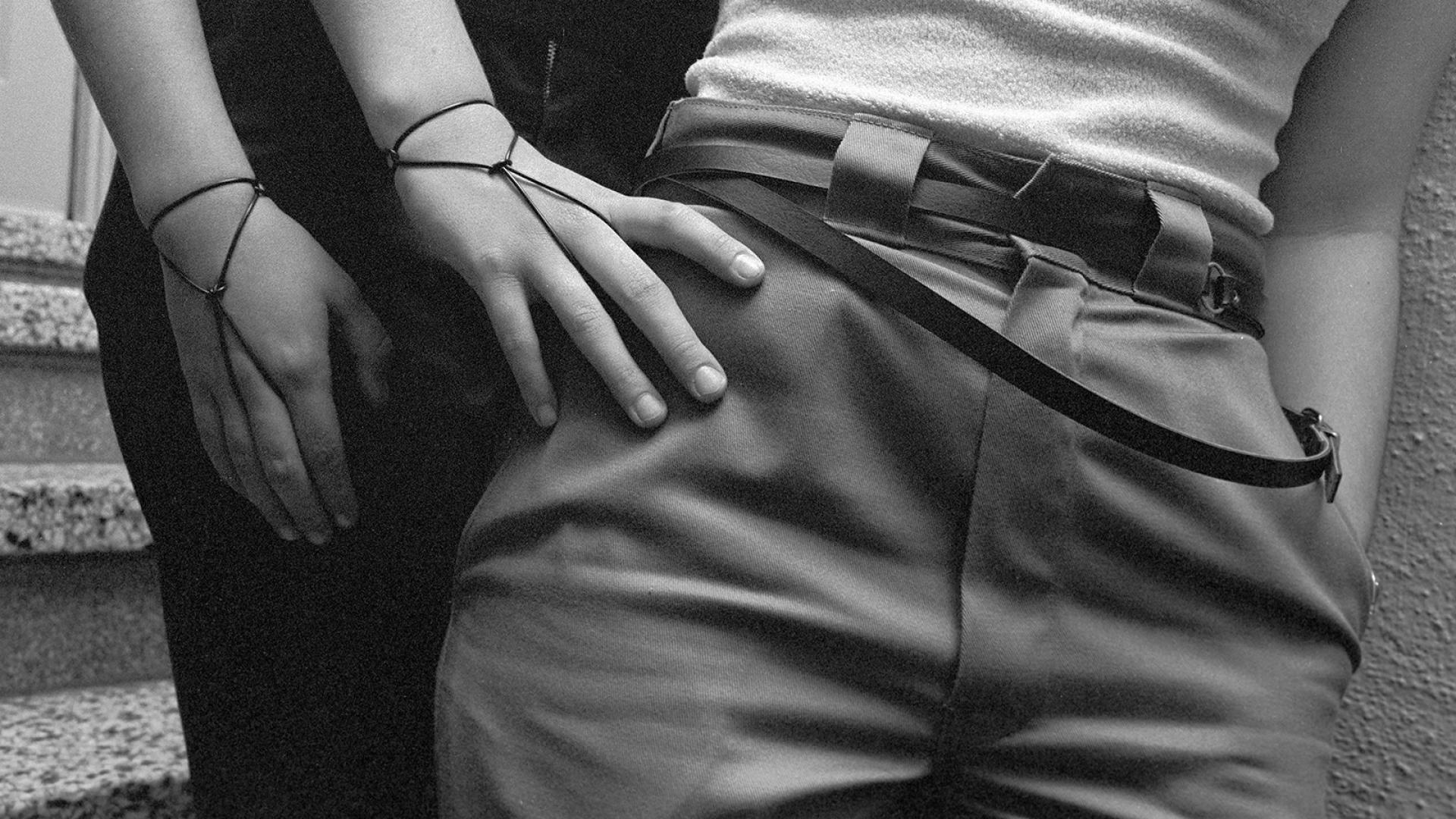 Black and white photograph of hands on hips