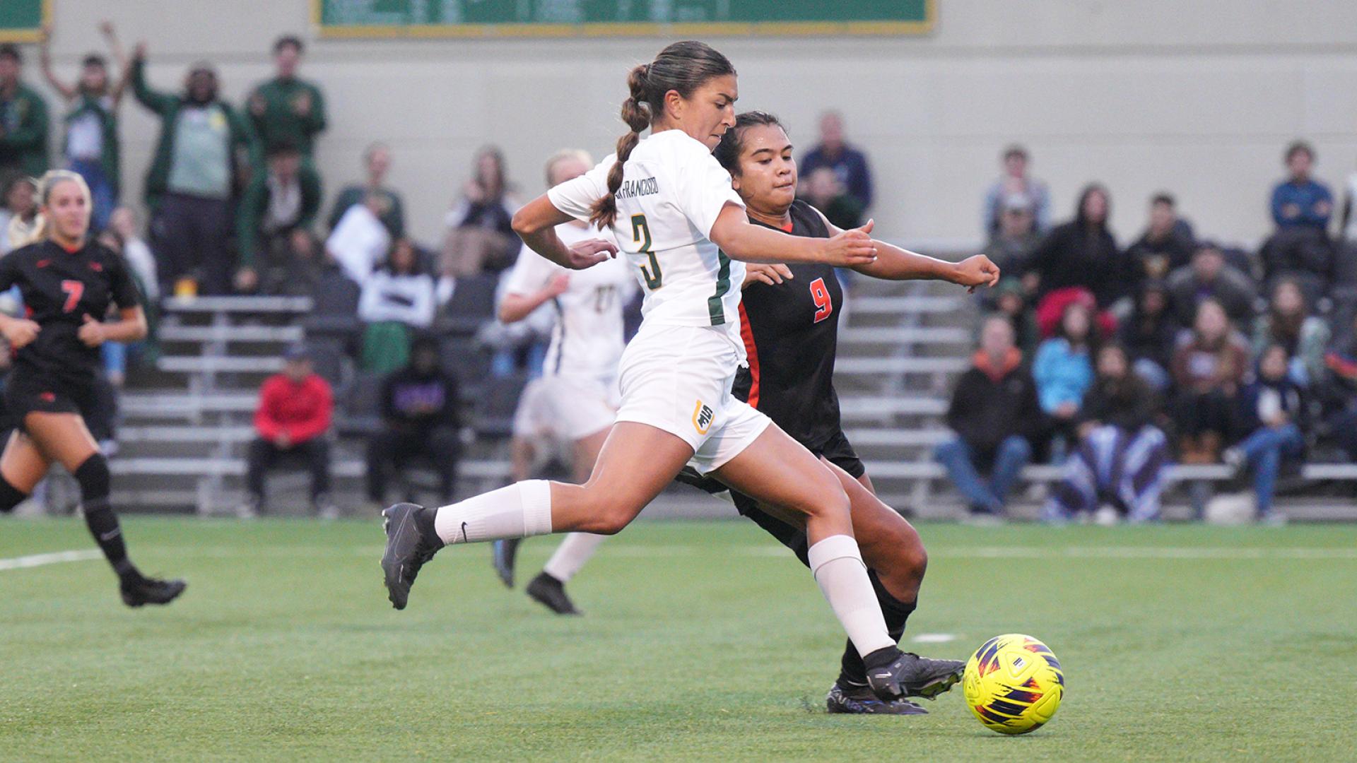 usf soccer playing kicking ball during game