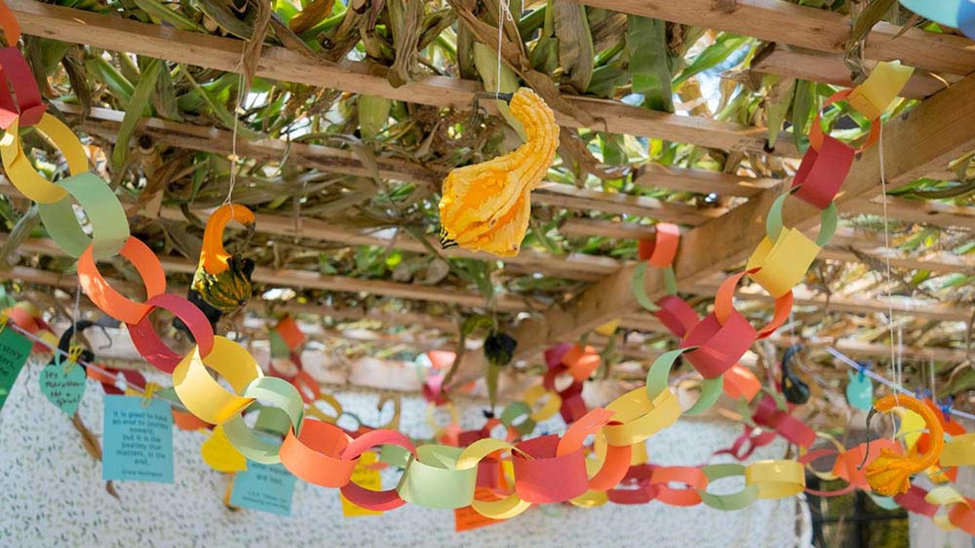 Paper chains adorn a sukkah covered with palm fronds