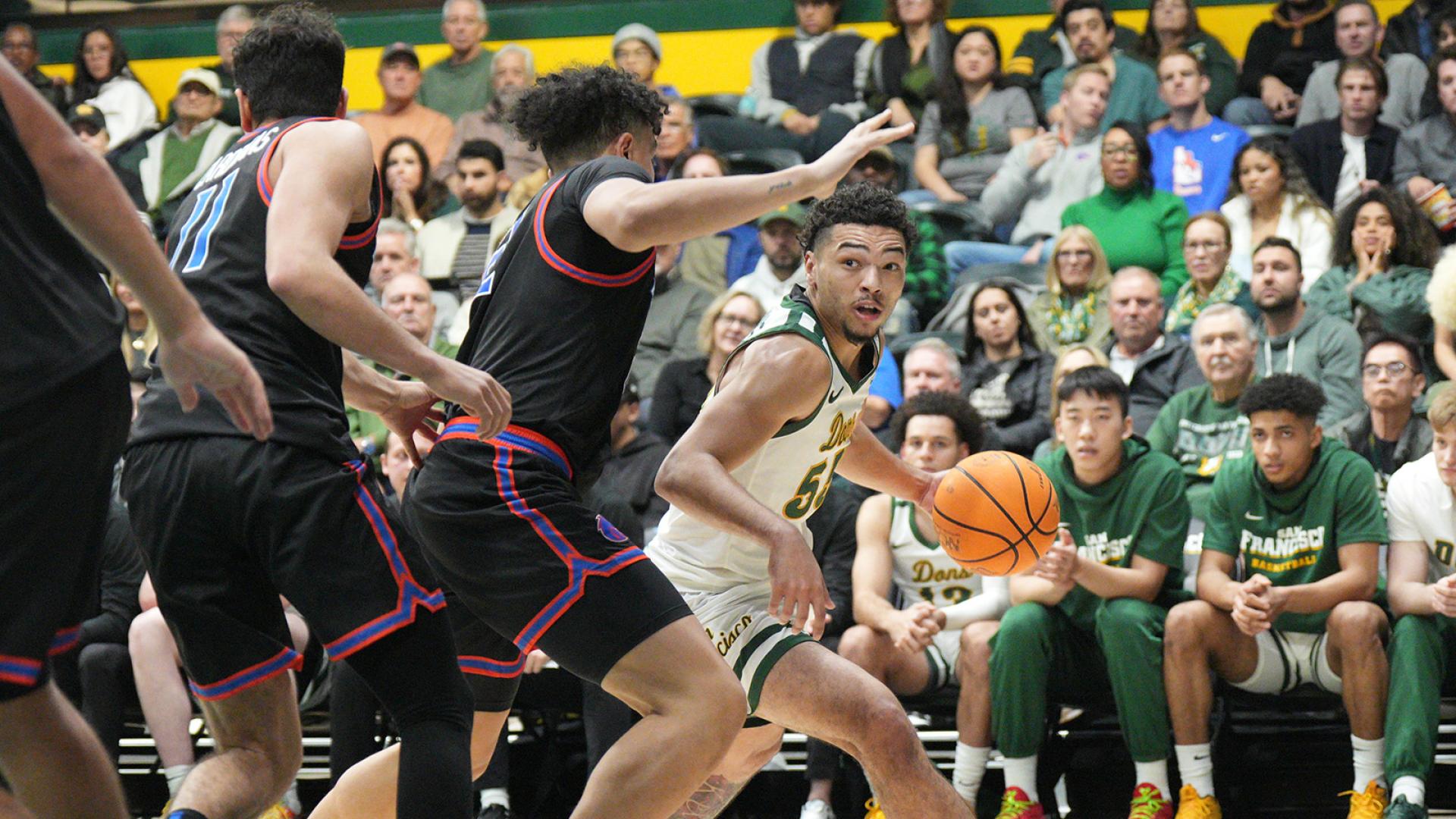 student runs with basketball during game