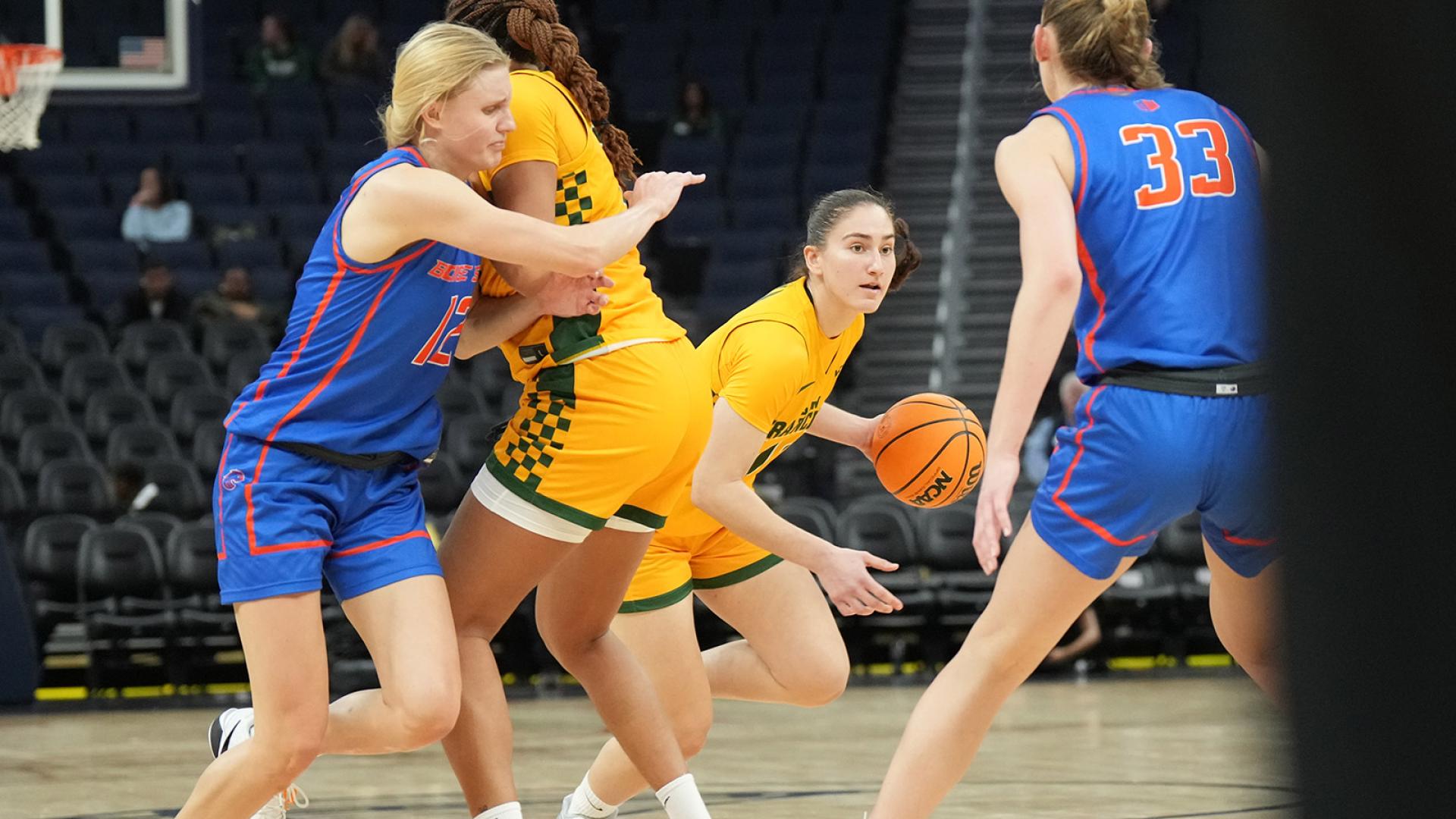 student athlete runs with basketball at the Chase Center auditorium