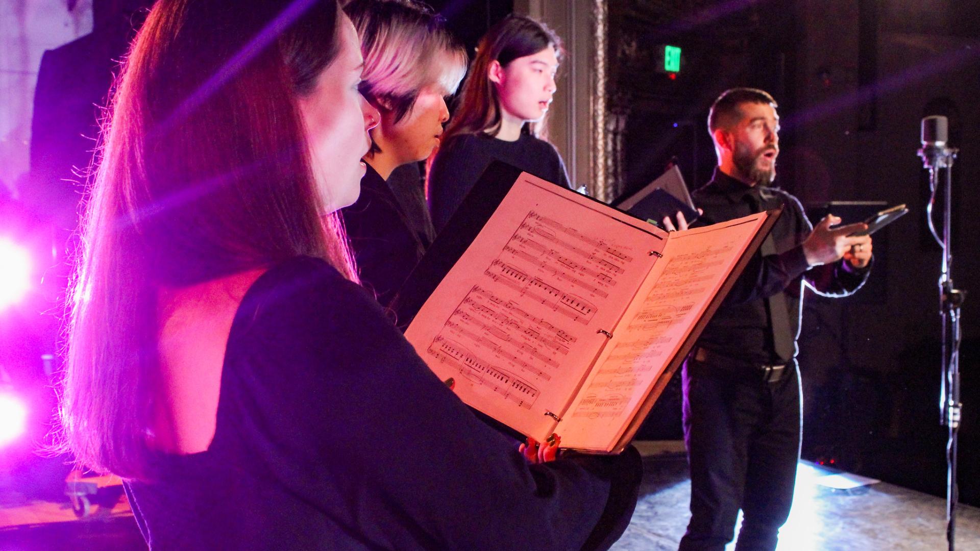 Choir ensemble performing in studio theater