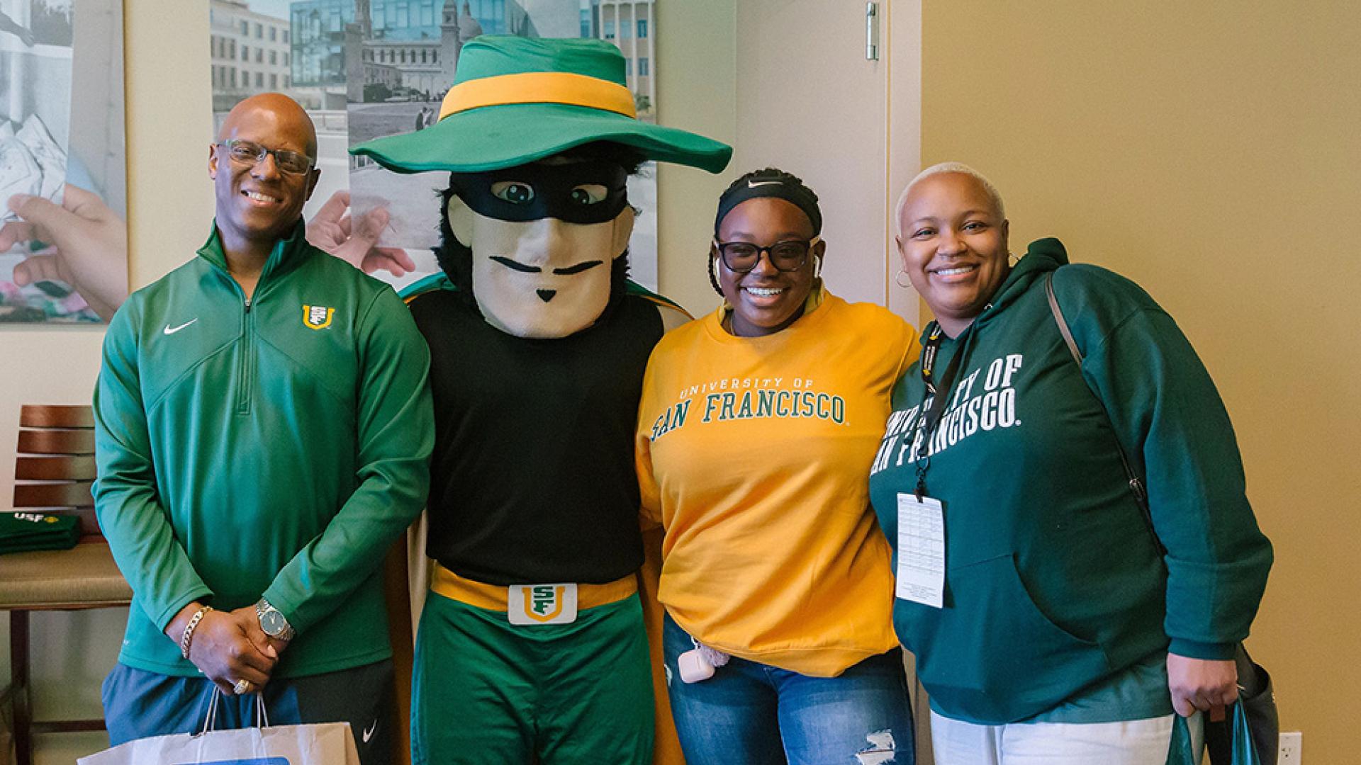 Group of people posing with USF mascot