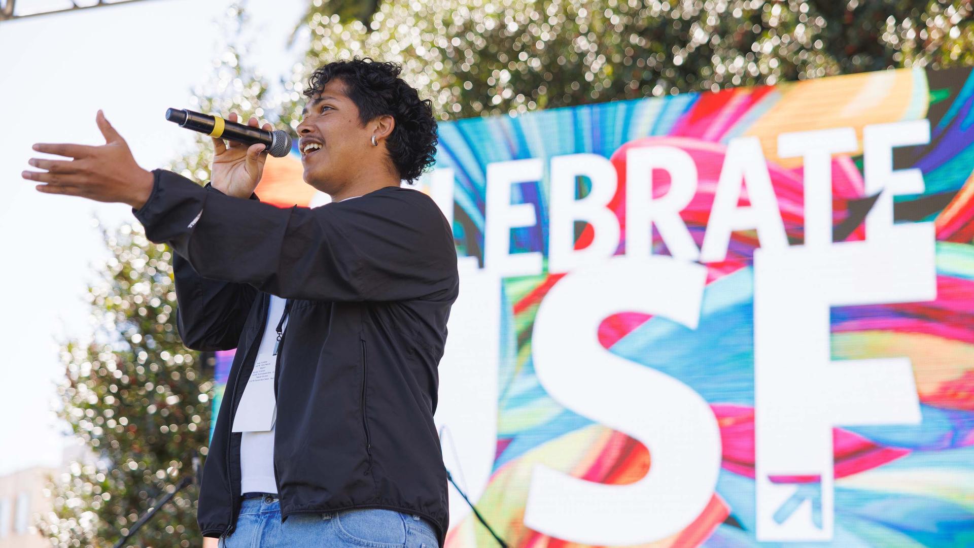 Person singing on stage at CelebrateUSF food and music festival