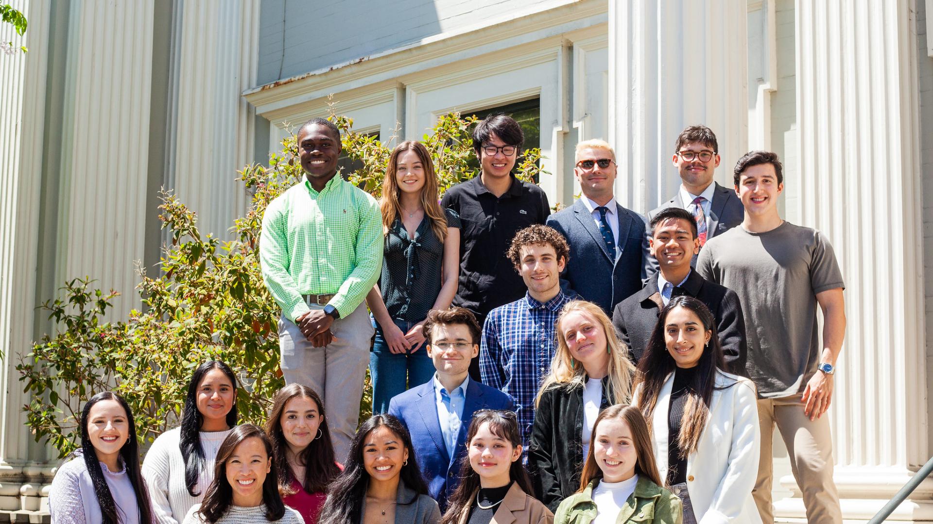 students stand in front of a building
