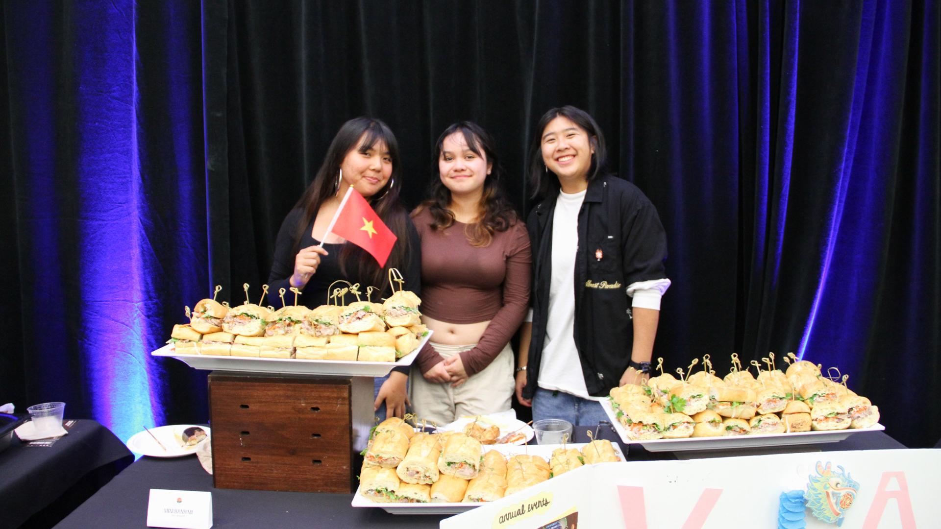 Students next to Vietnamese Sandwiches, representing the country