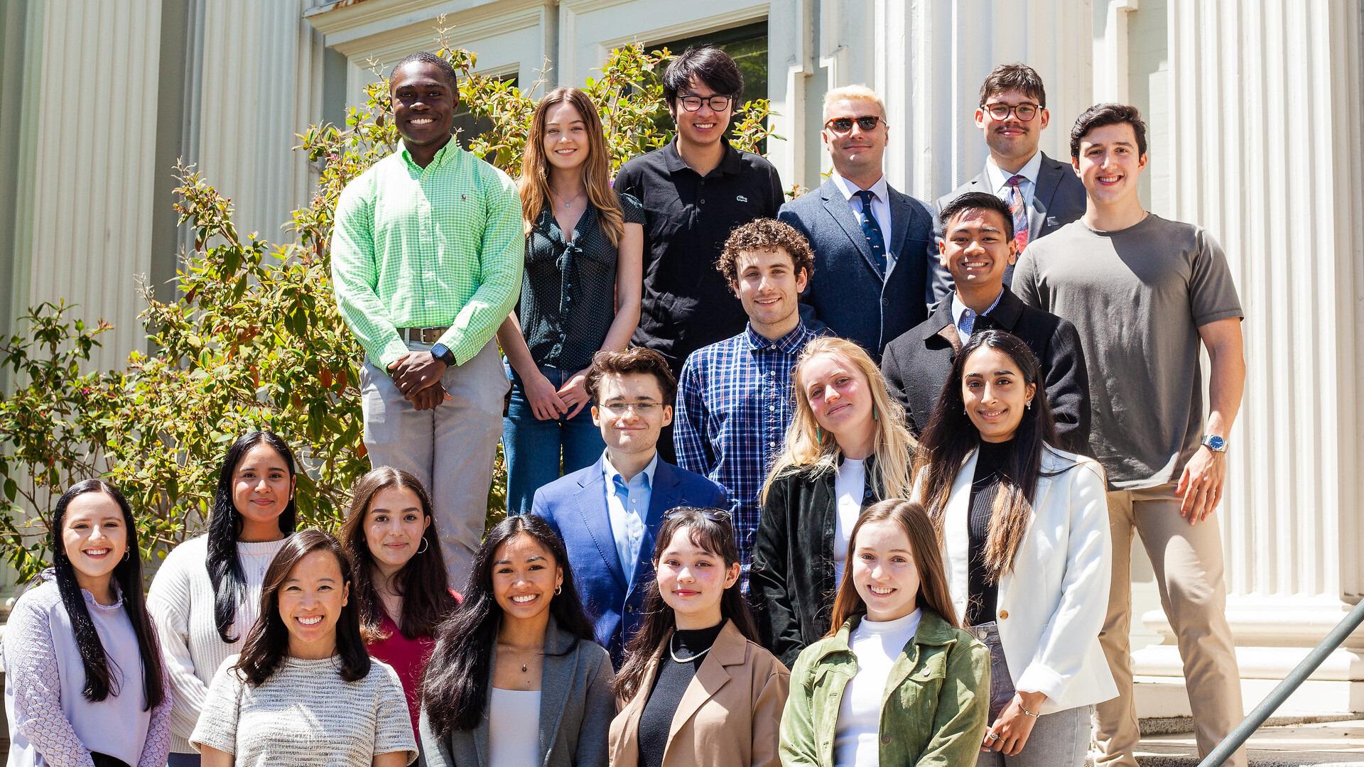 students stand in front of a building