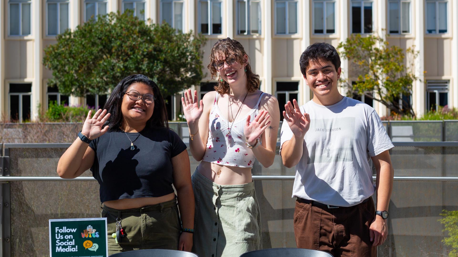 students waving