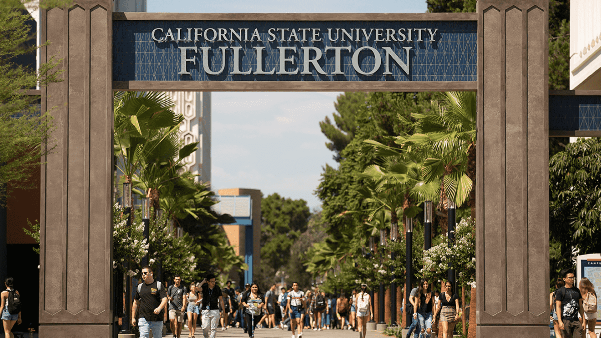 CSU Fullerton sign with students walking