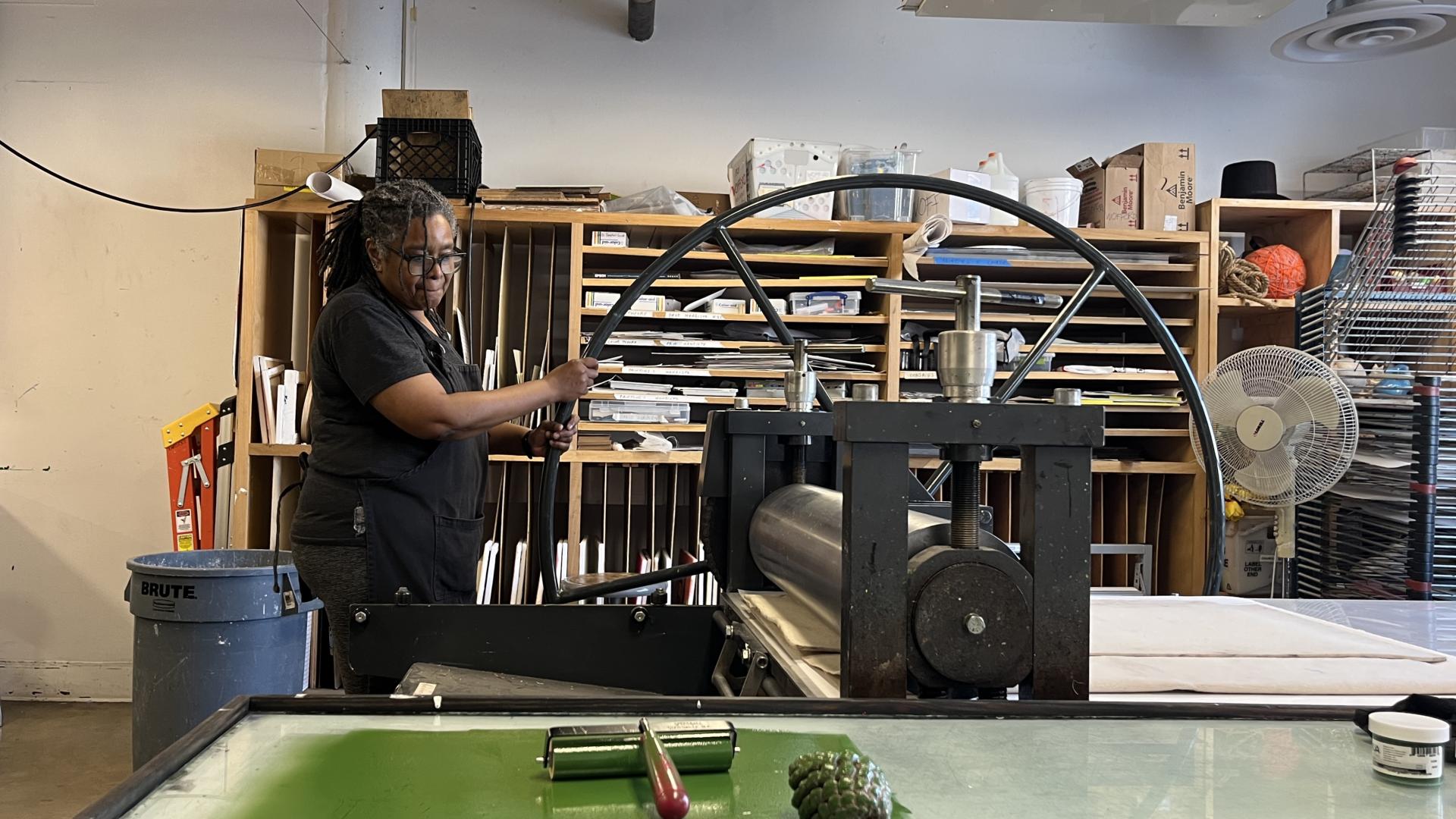 Cheryl Derricotte using a round paper press 