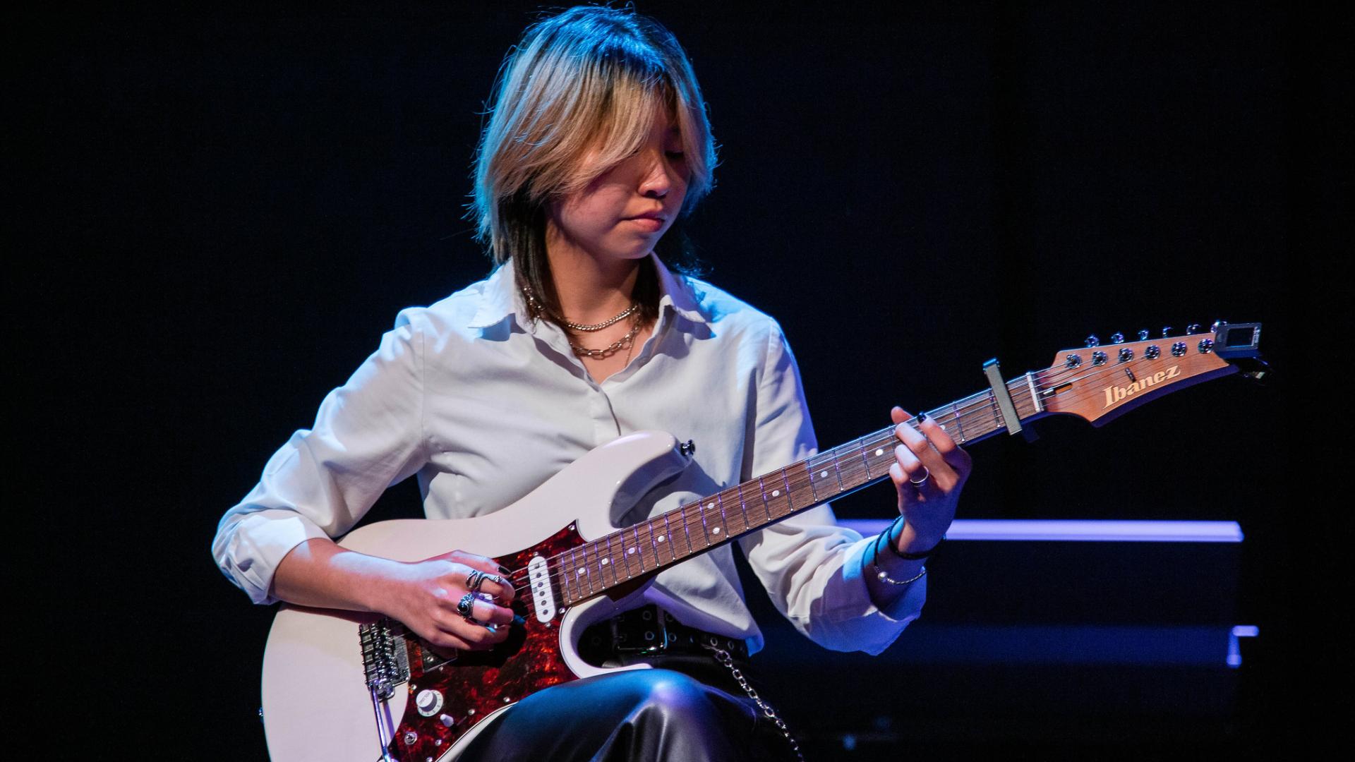 student musician playing the guitar
