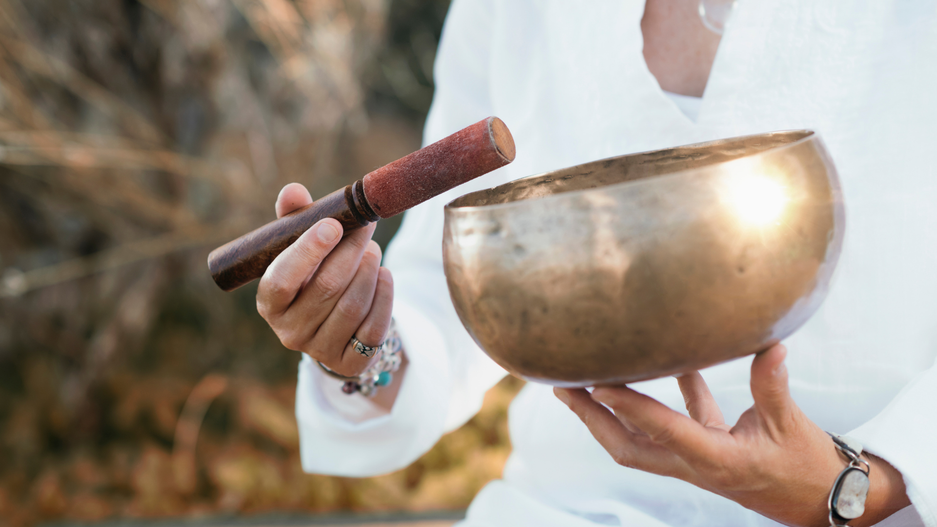 person holding singing bowl 