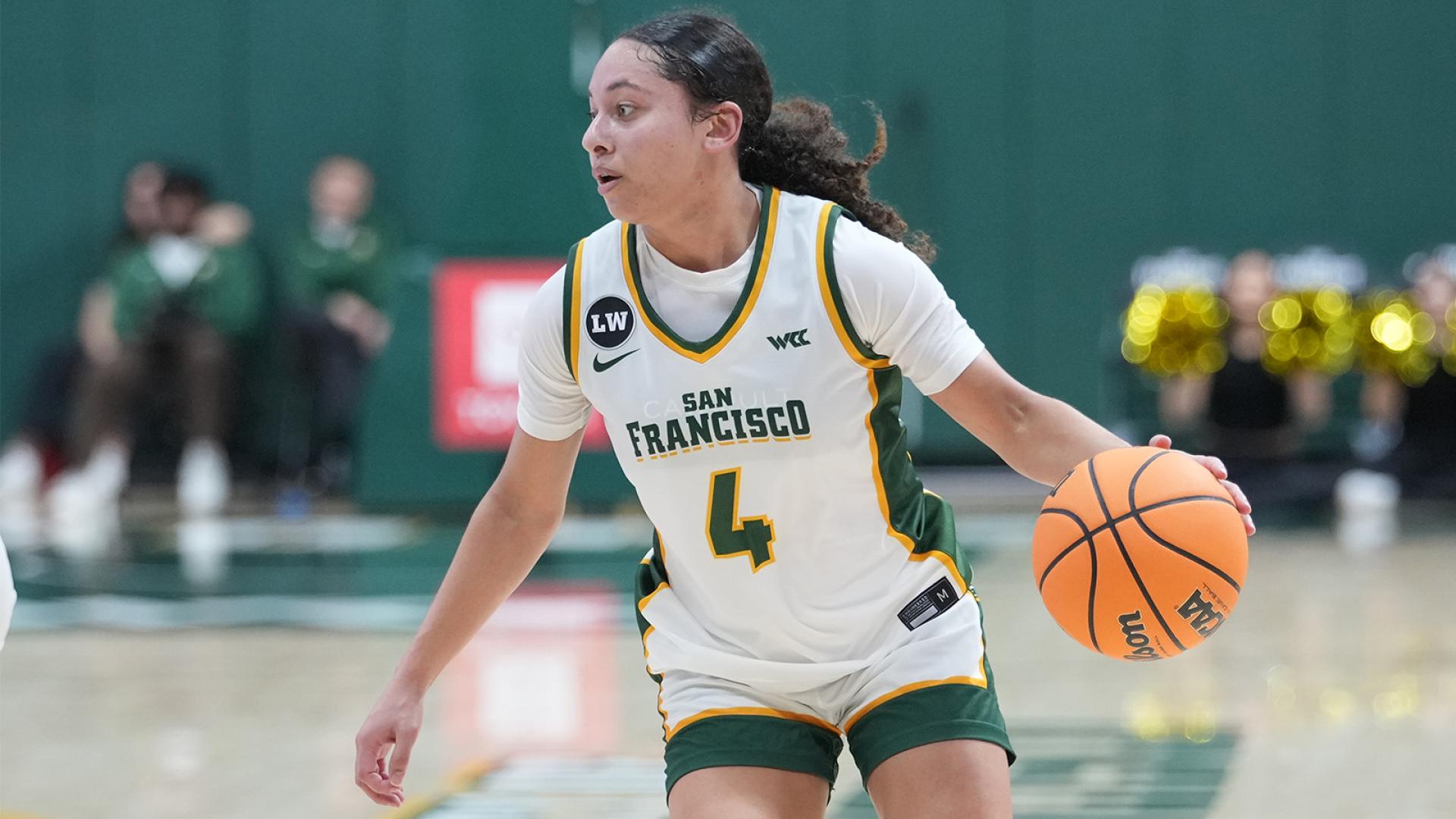 USF women's basketball player dribbling