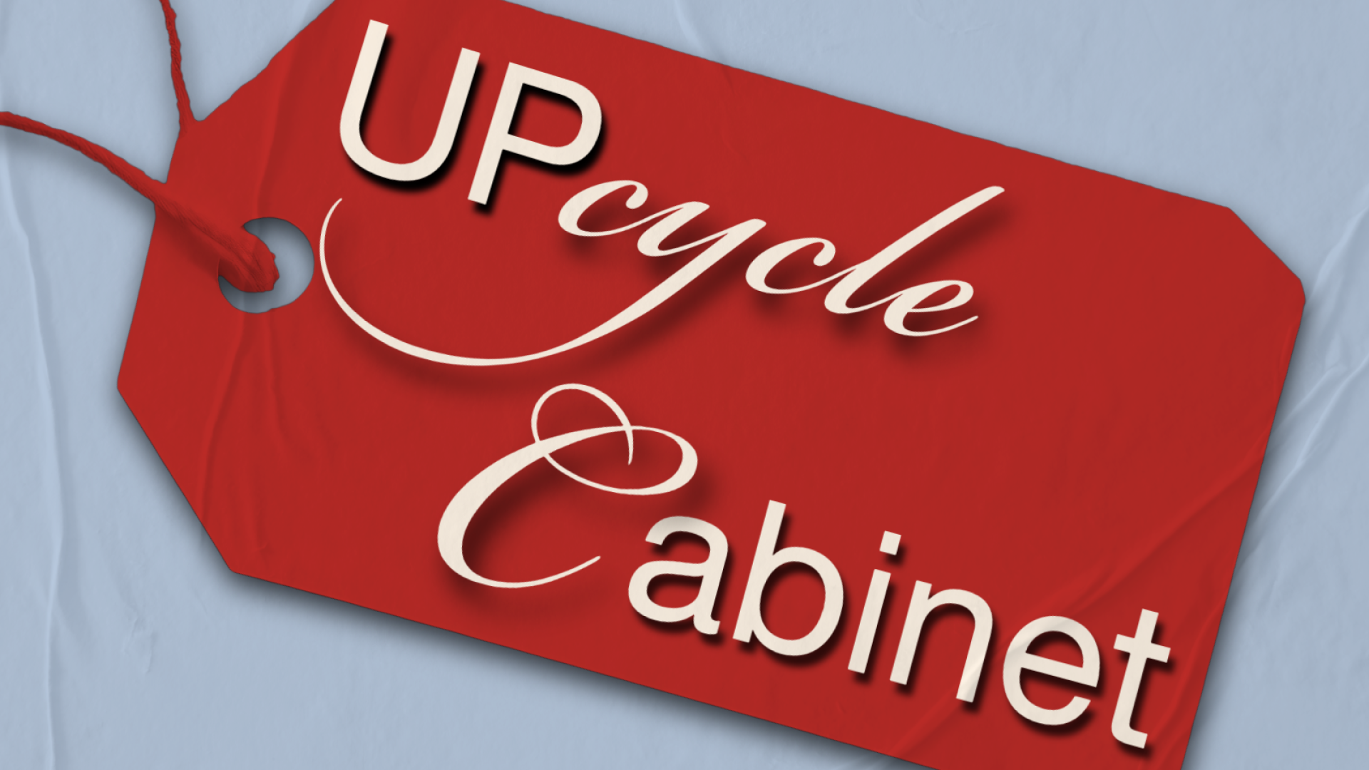Clothing tag that reads "Upcycle Cabinet"