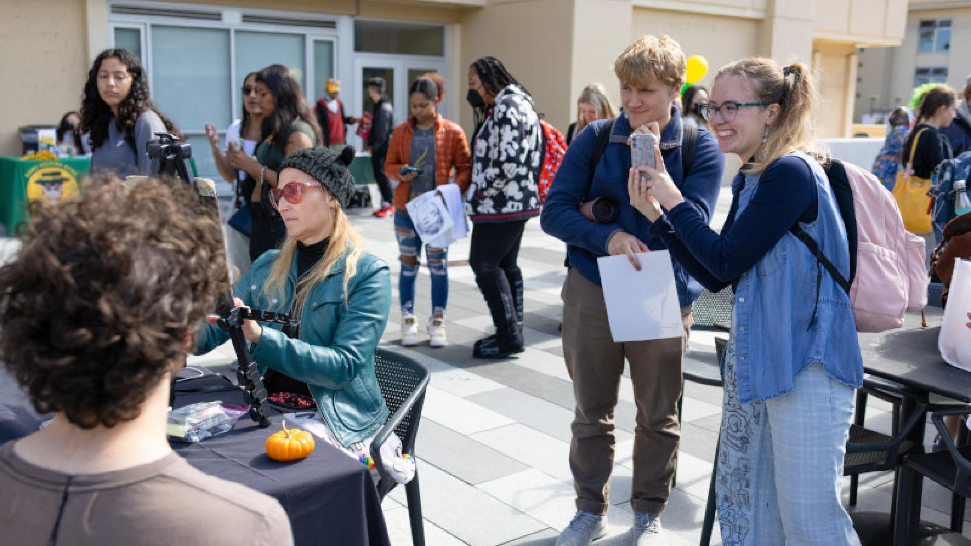 Group of students crowded around for 50 Days event.