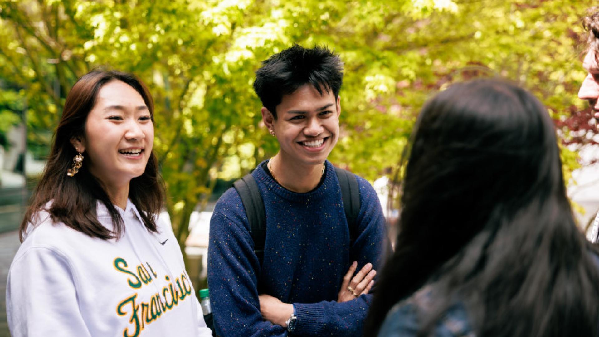 Three students having a conversation.