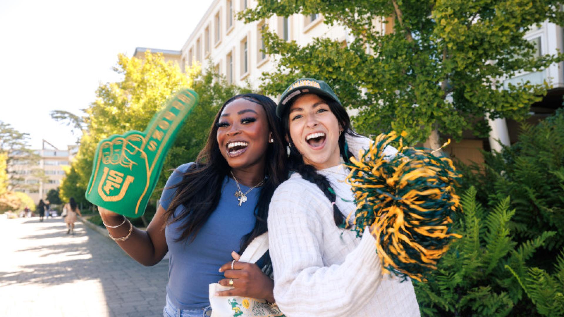 Two students cheering with USF gear.