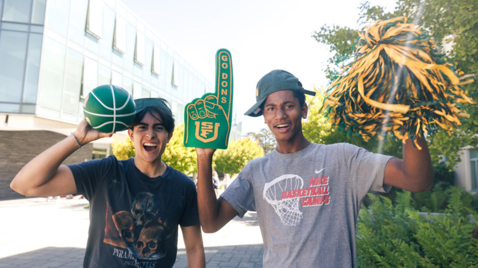 Two students cheering with USF gear.