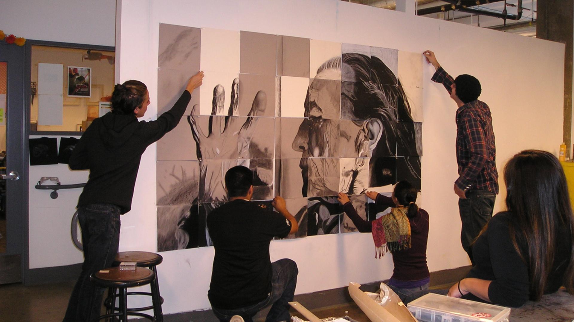 Art students working on a mural of artist Louise Bourgeois