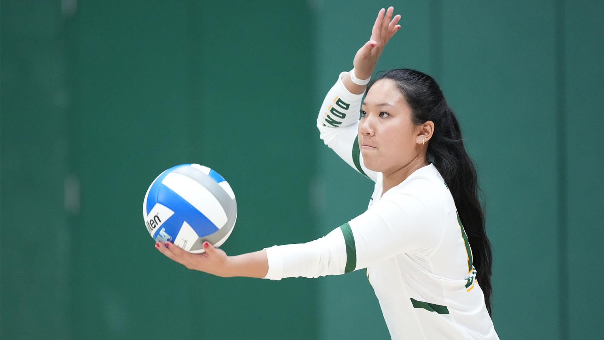 Womens volleyball player serving