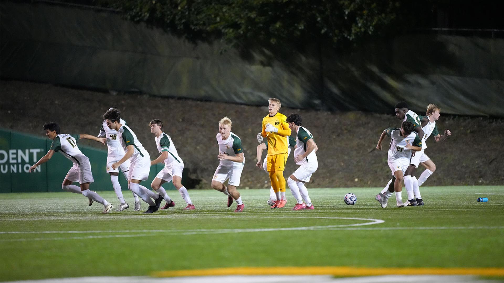 Mens soccer team on field running