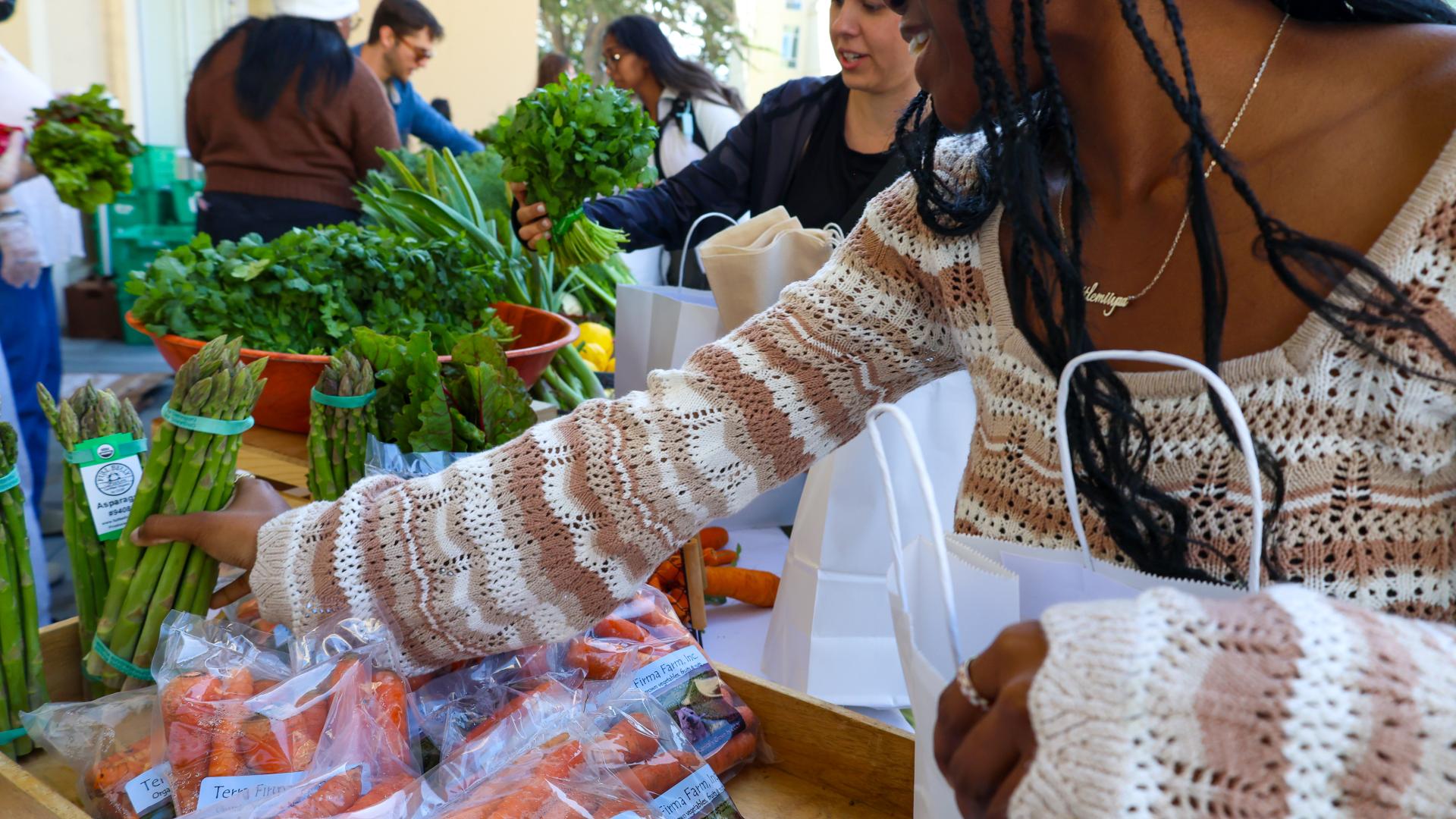 students with bags getting vegetables