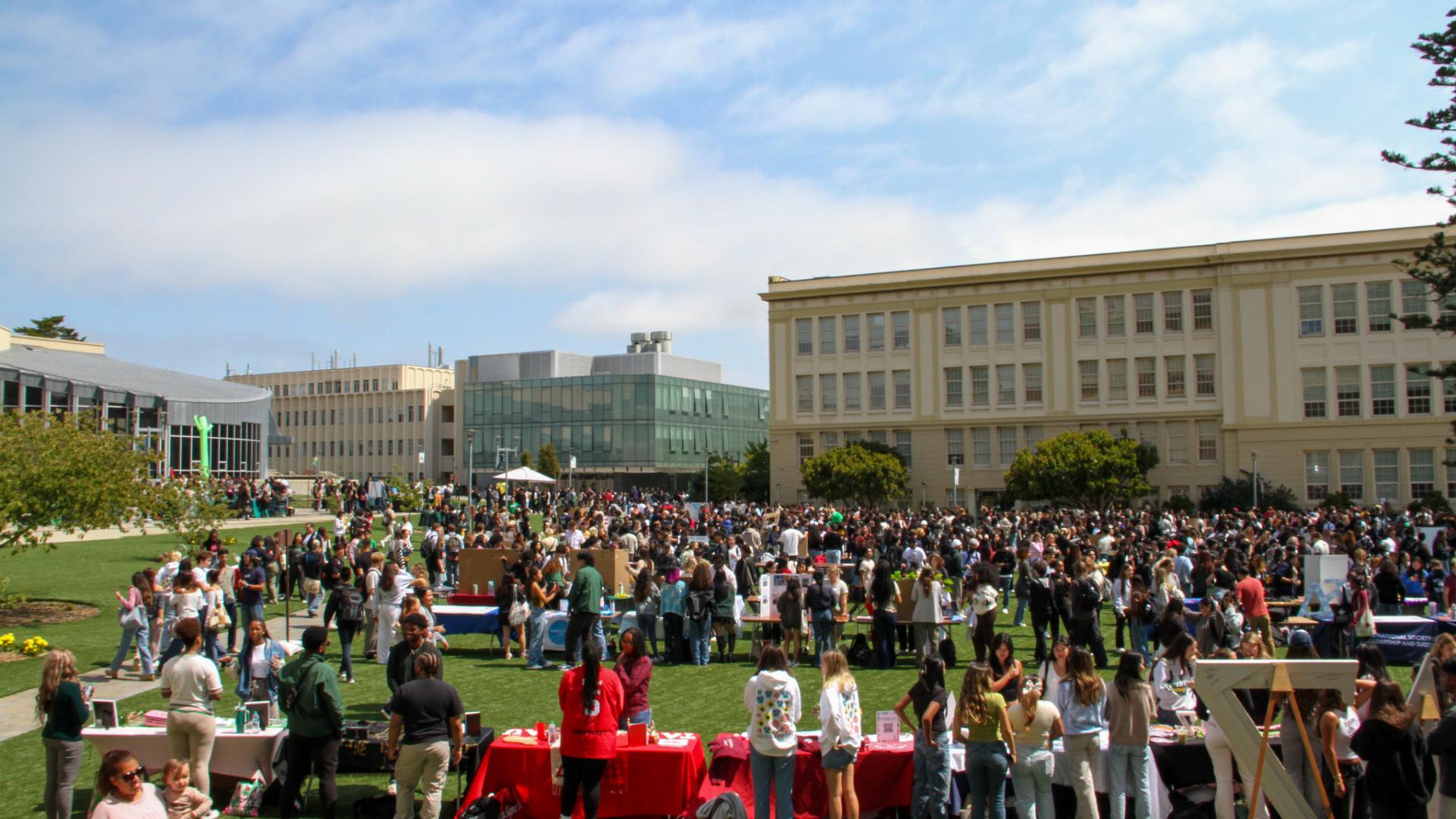 Students outside on Welch Field tabling for student organizations