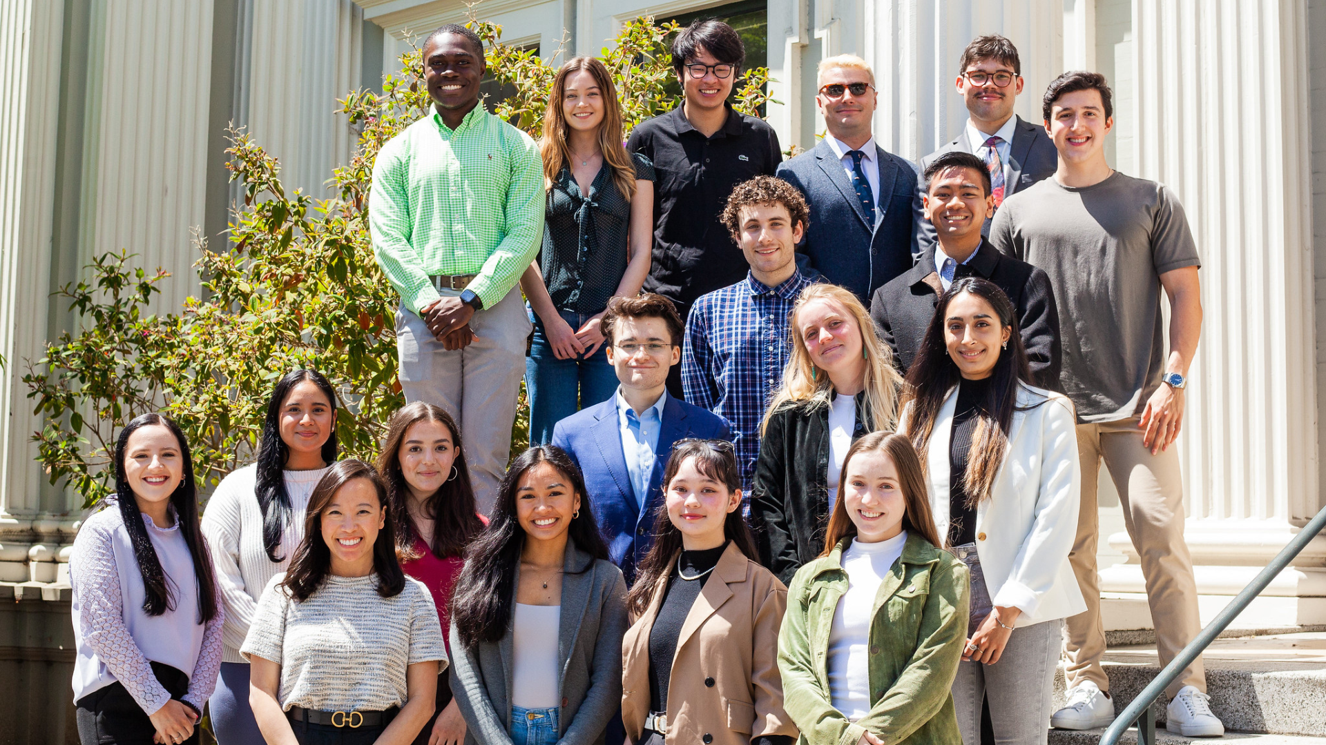 students stand in front of a building