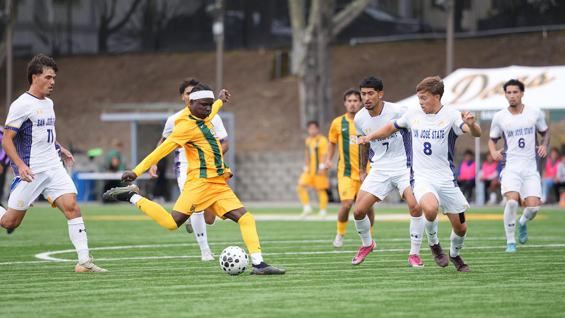 soccer player runs with ball during match