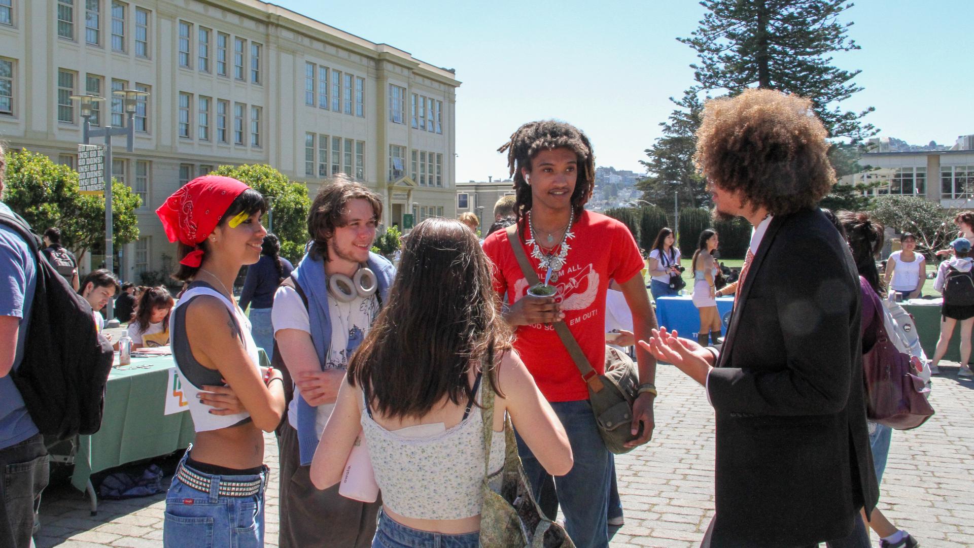 SIRC image of students in a standing group discussing outside 